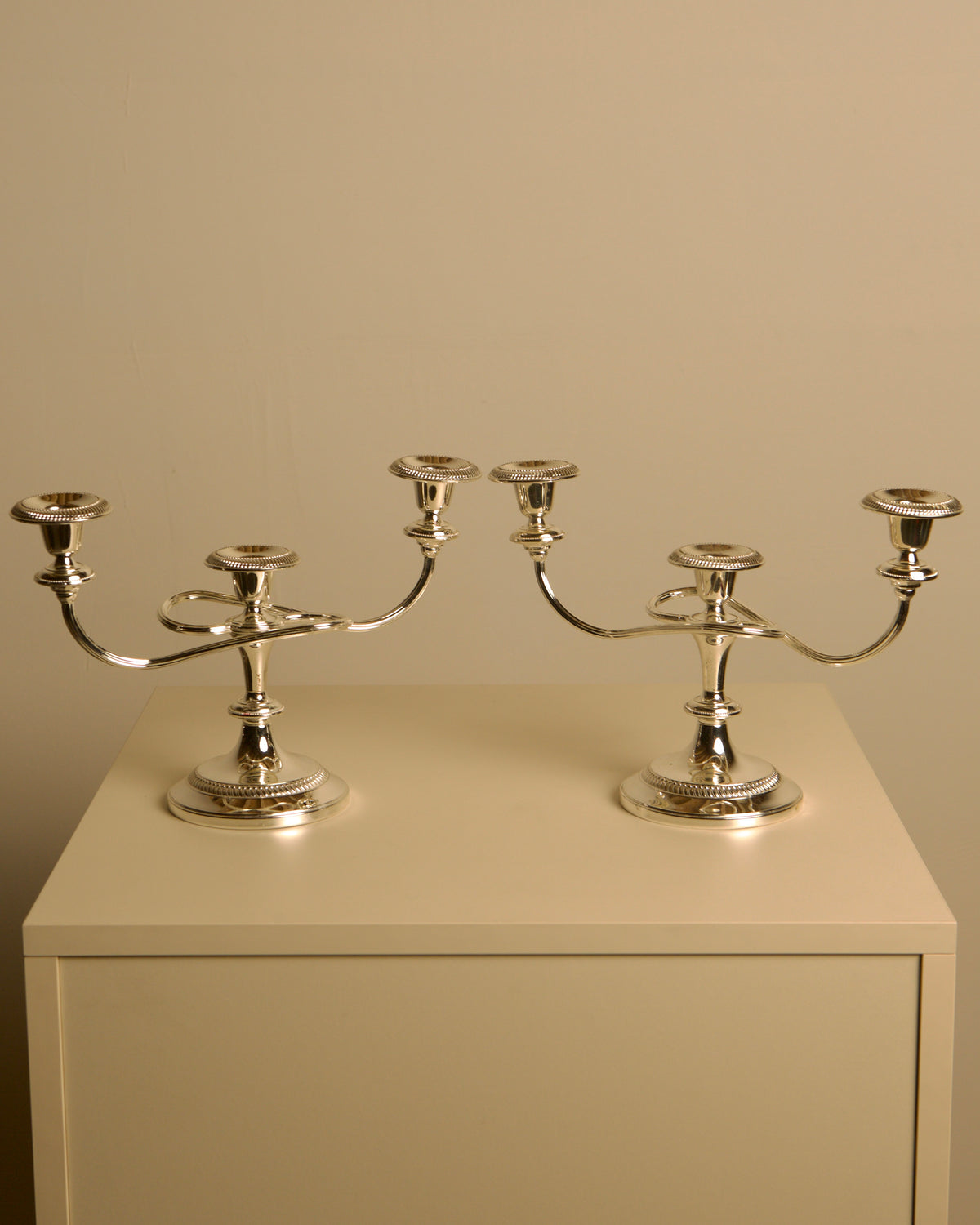 Pair of Italian metal "Medusa" candlesticks, 1980s — close-up of polished silver finish