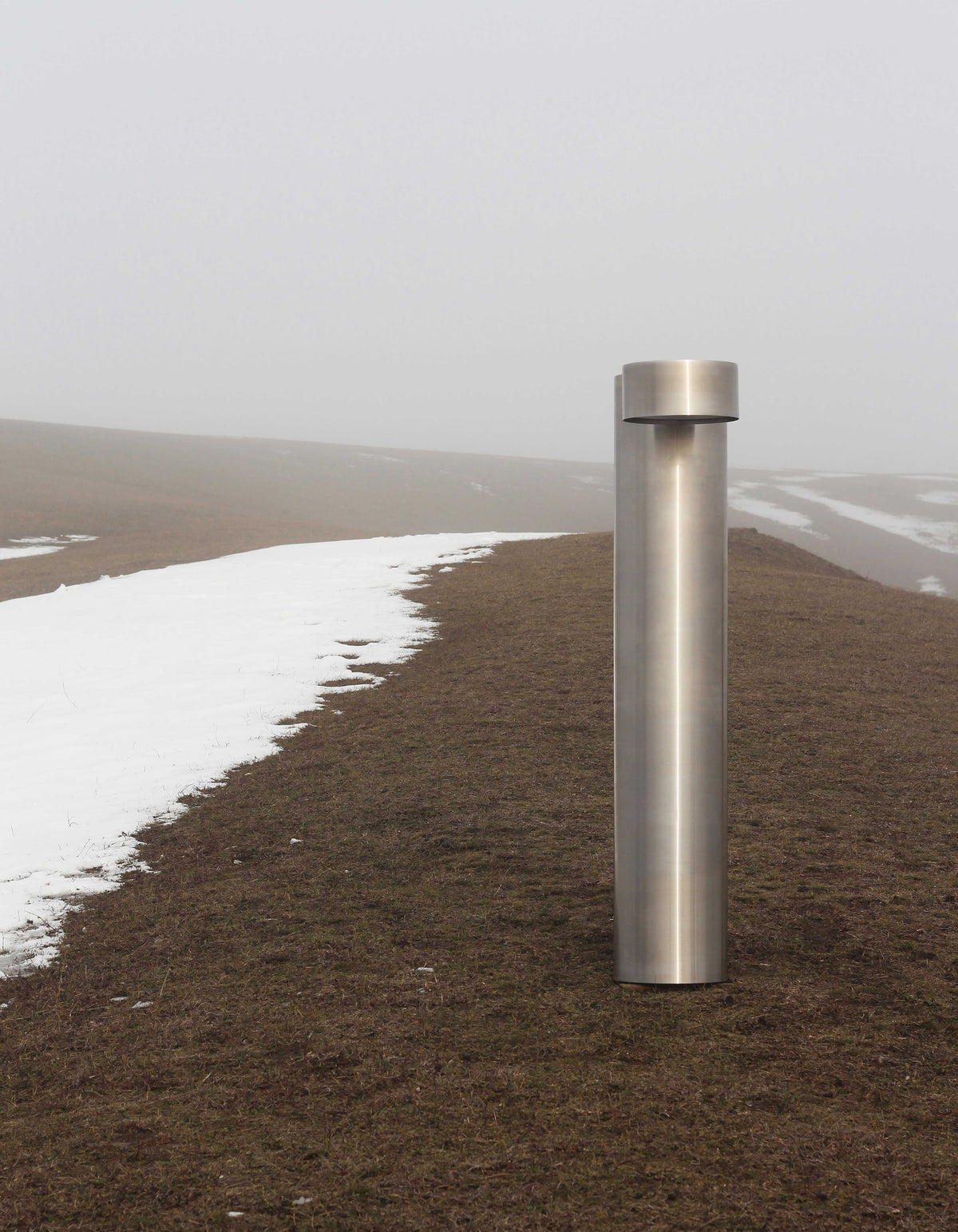 X floor lamp — stainless steel design in outdoor setting