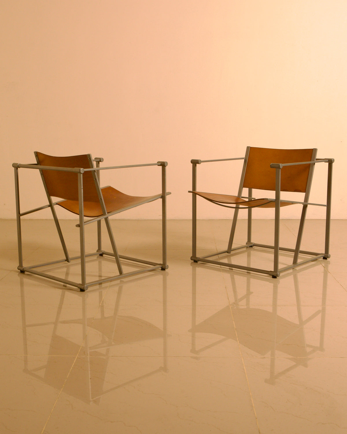 Pair of "FM62" Armchairs by Radboud van Beekum for Pastoe, 1980s — angled view highlighting leather seat and metal frame