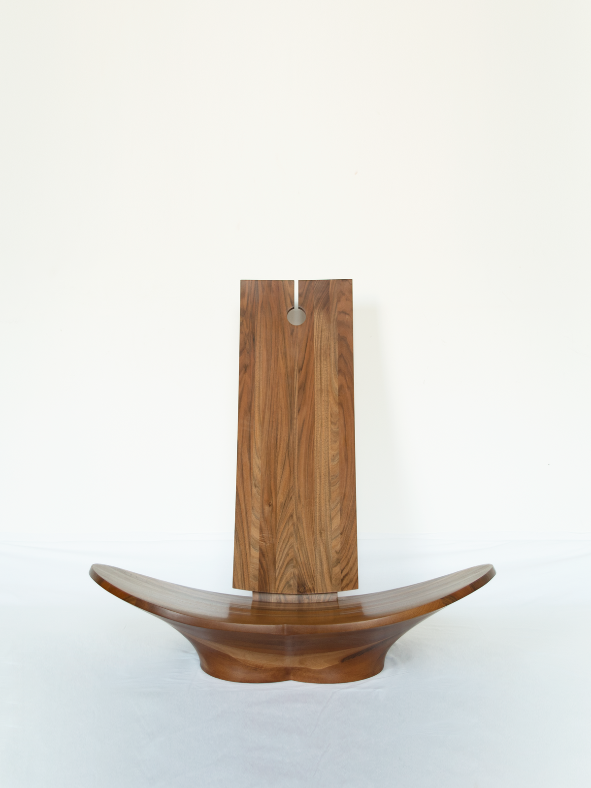Lotus Armchair — side angle showing curved wooden seat and back
