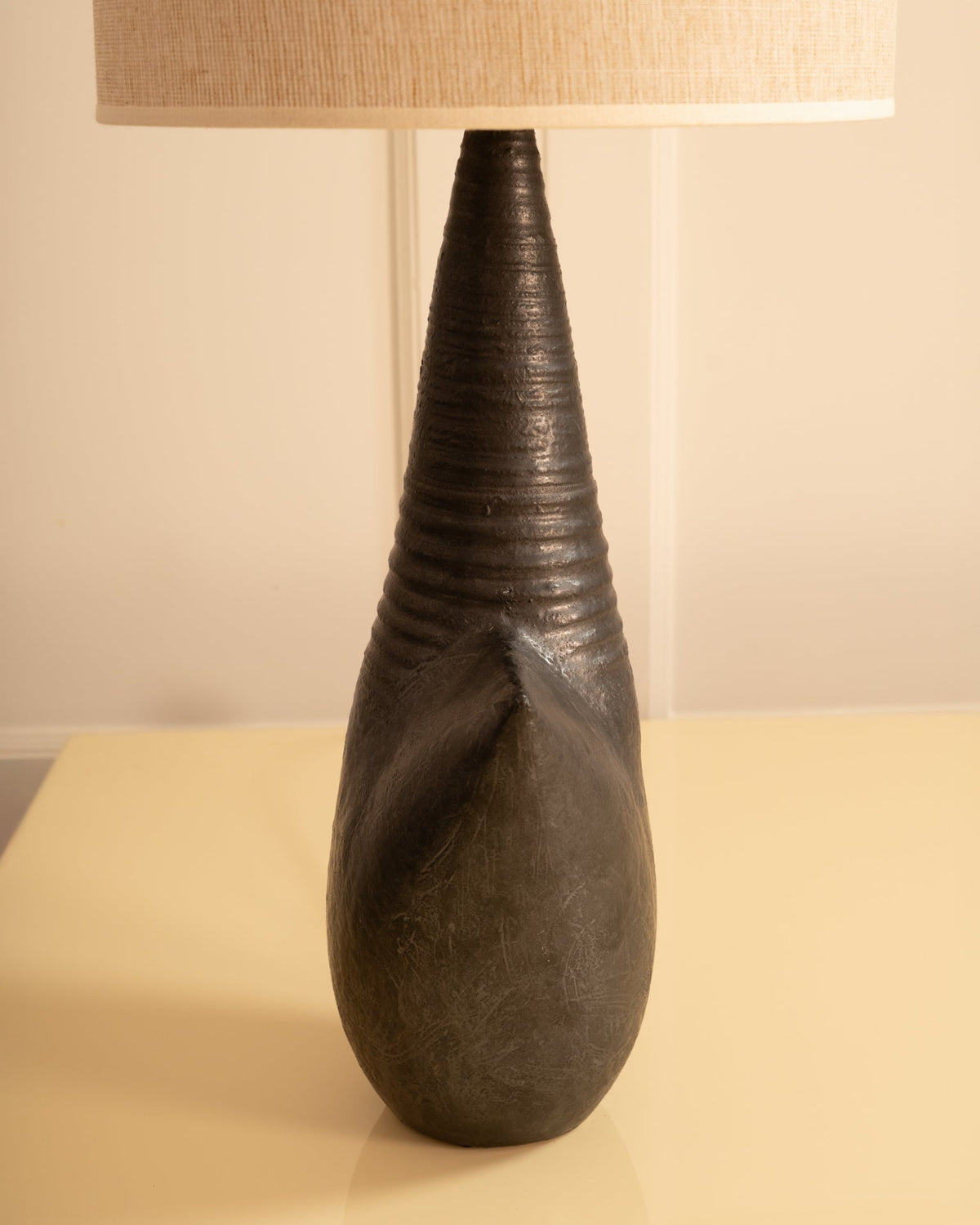 Dark stoneware table lamp with ridged conical neck and bulbous base