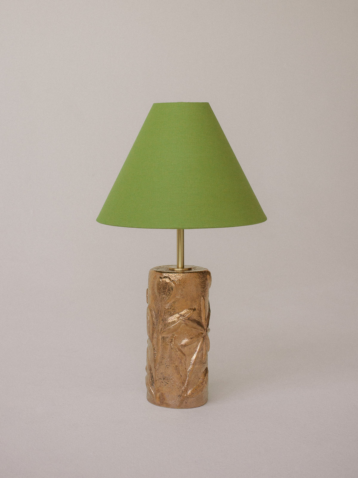 Gold ceramic table lamp with textured botanical base and lime green shade