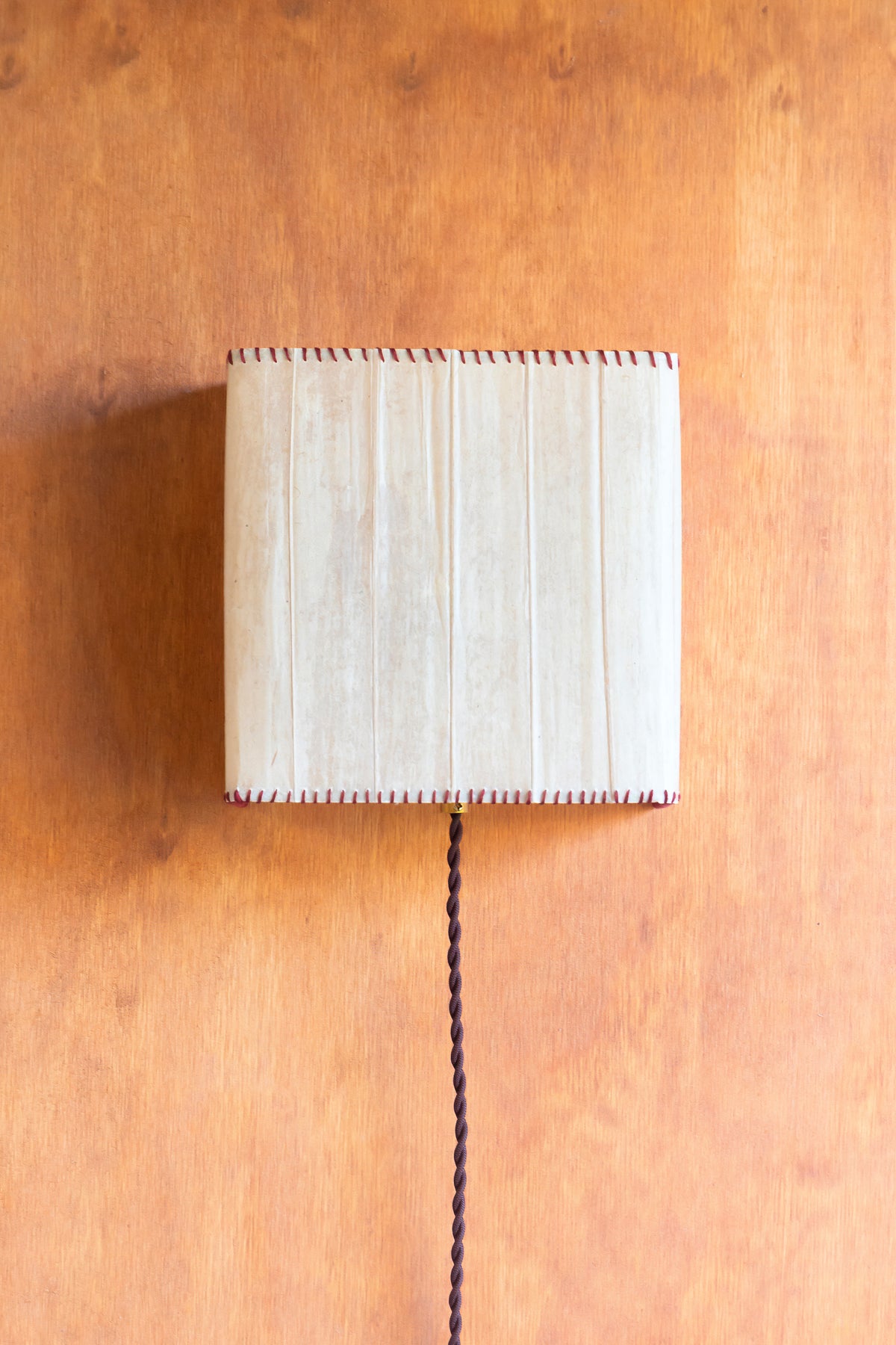 Magdalena Sconce — mounted on textured orange wall with cord