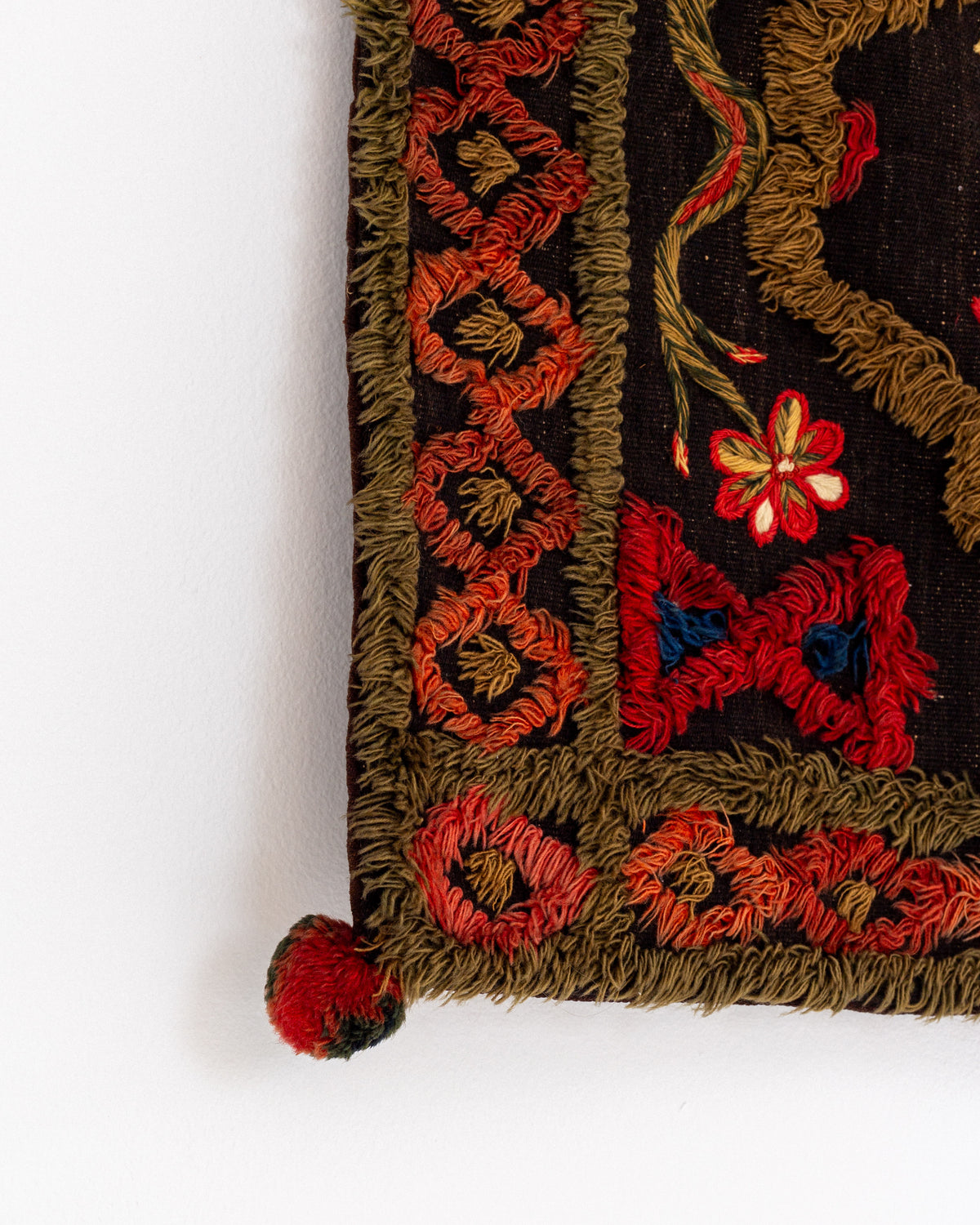 Detail of antique Swedish wedding tapestry corner with floral embroidery