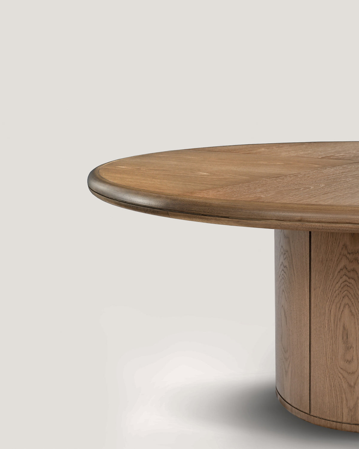Moon round dining table edge detail showing wood grain and metal trim