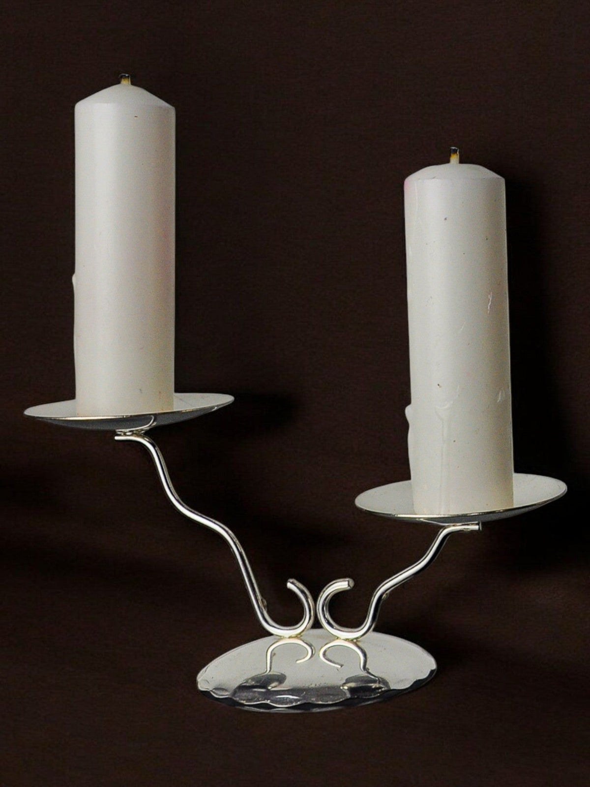 Art deco Candleholder, Spain, 1980s — close-up of silver metal base with two white candles