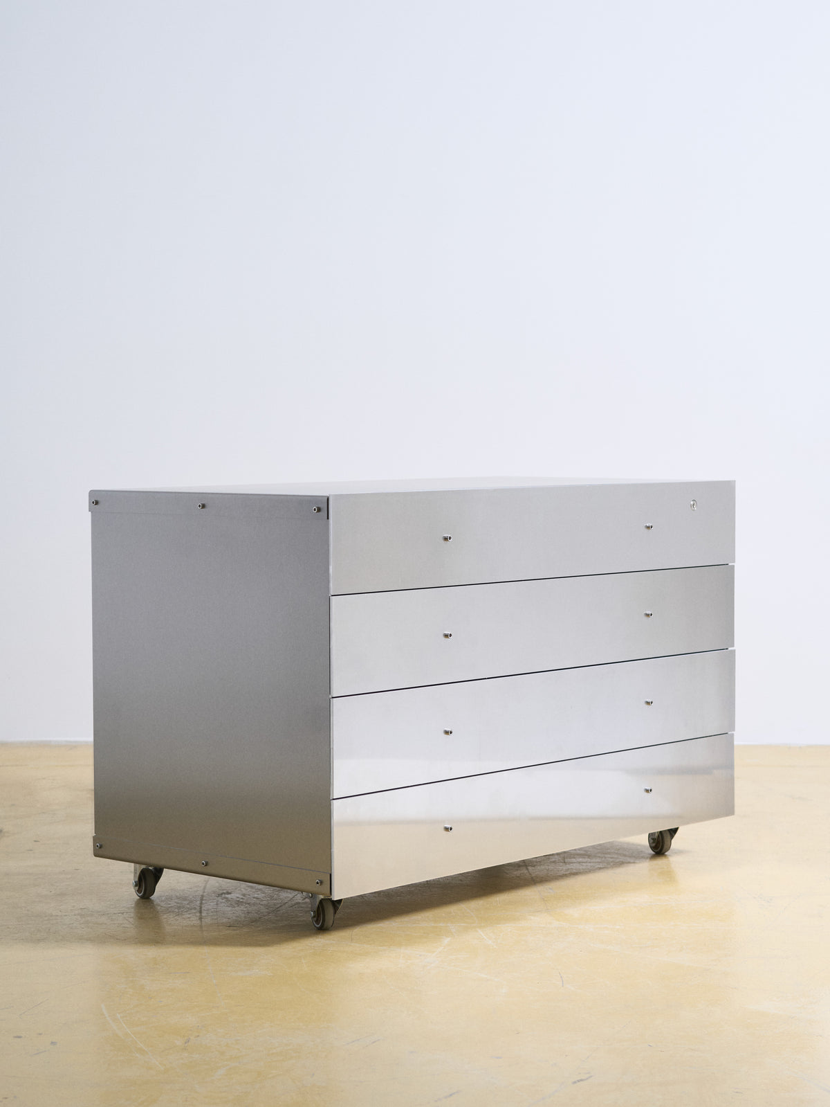 Chest of Drawers — side angle showing polished metal finish