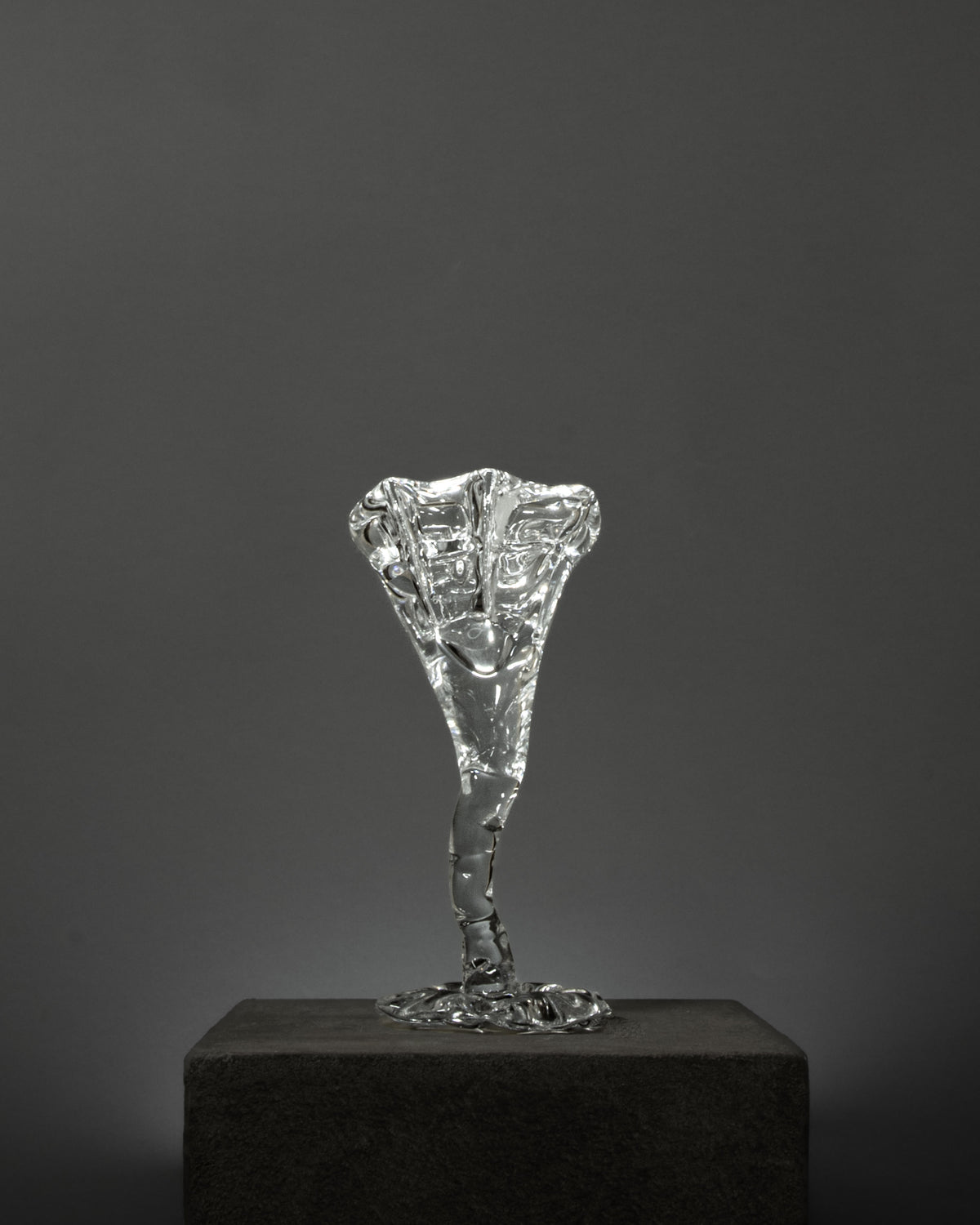 Spiky Cocktail Glass - Transparent — side angle on textured pedestal