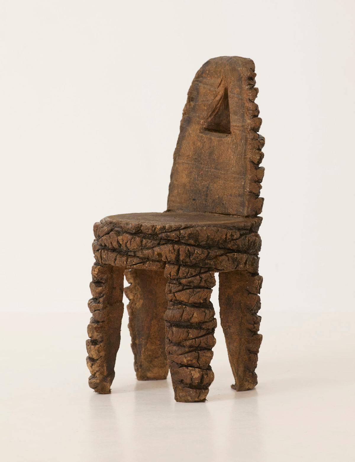 Small Artisanal Brutalist Chair in Solid Palm Tree C. 1970 — side angle highlighting textured wood finish