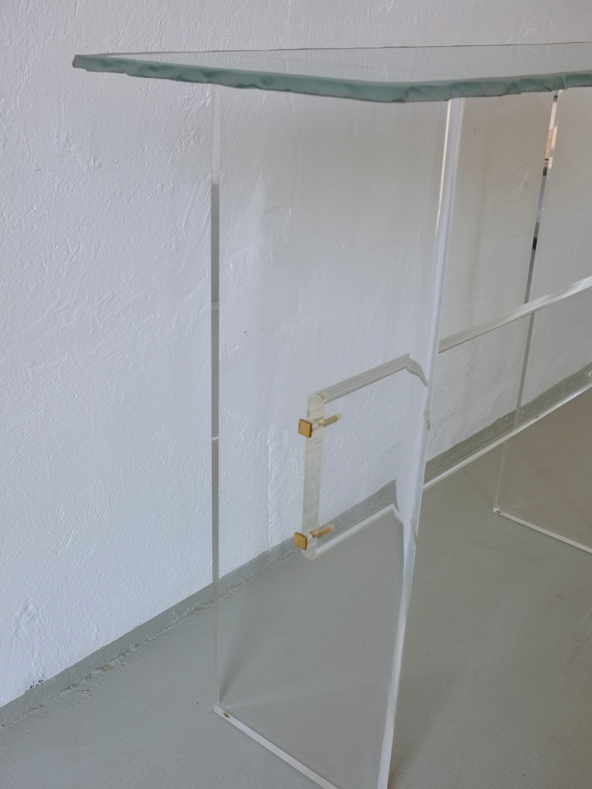 Clear acrylic console table with glass top detail view