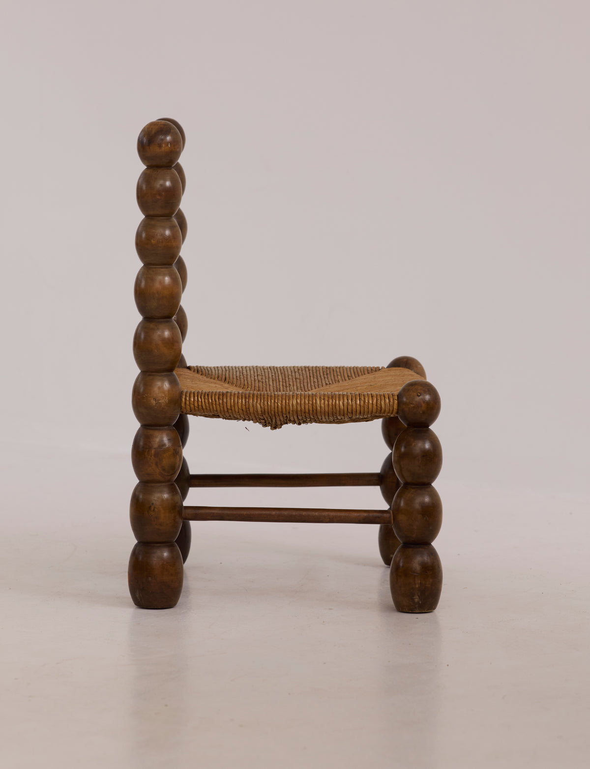 Vintage French Oak Wood and Straw Low Chair C. 1940 — side view highlighting rounded wooden legs