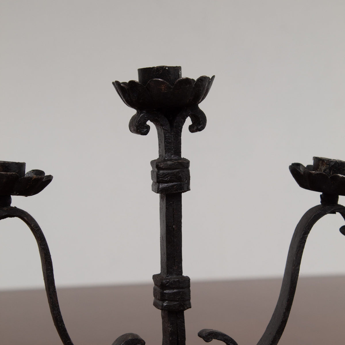 Pair of Brutalist Iron Candleholders with Sculptural Scroll Arms — side angle