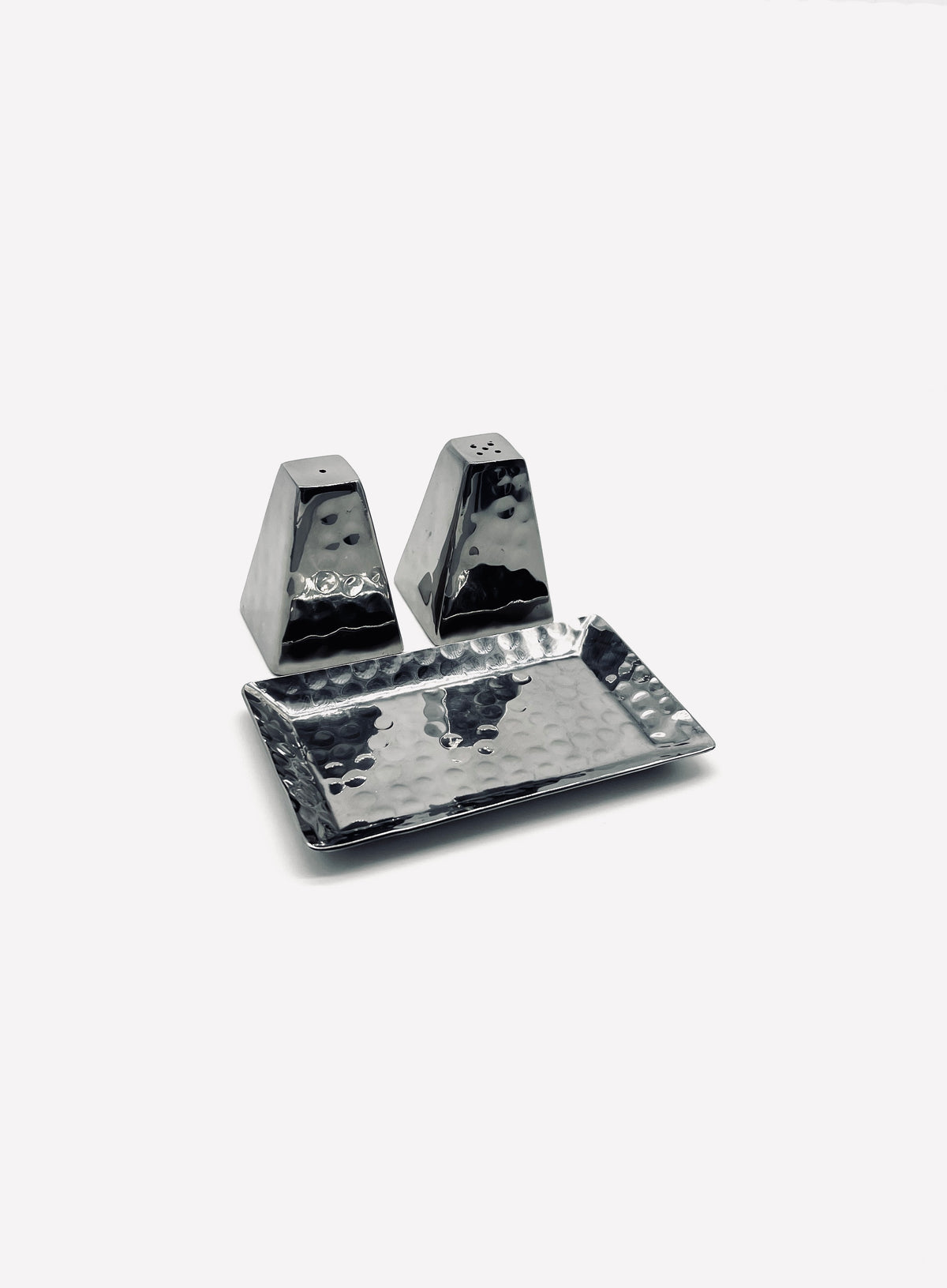 Hammered stainless steel salt and pepper shakers on matching tray
