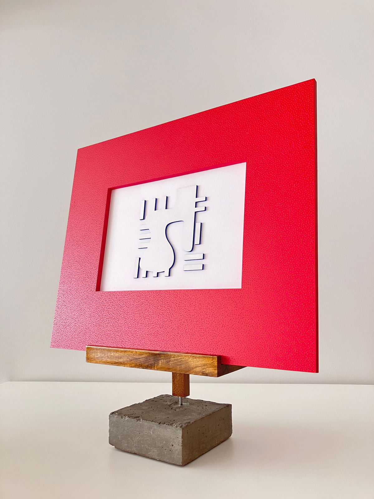Red picture frame display easel with concrete base and wooden arm