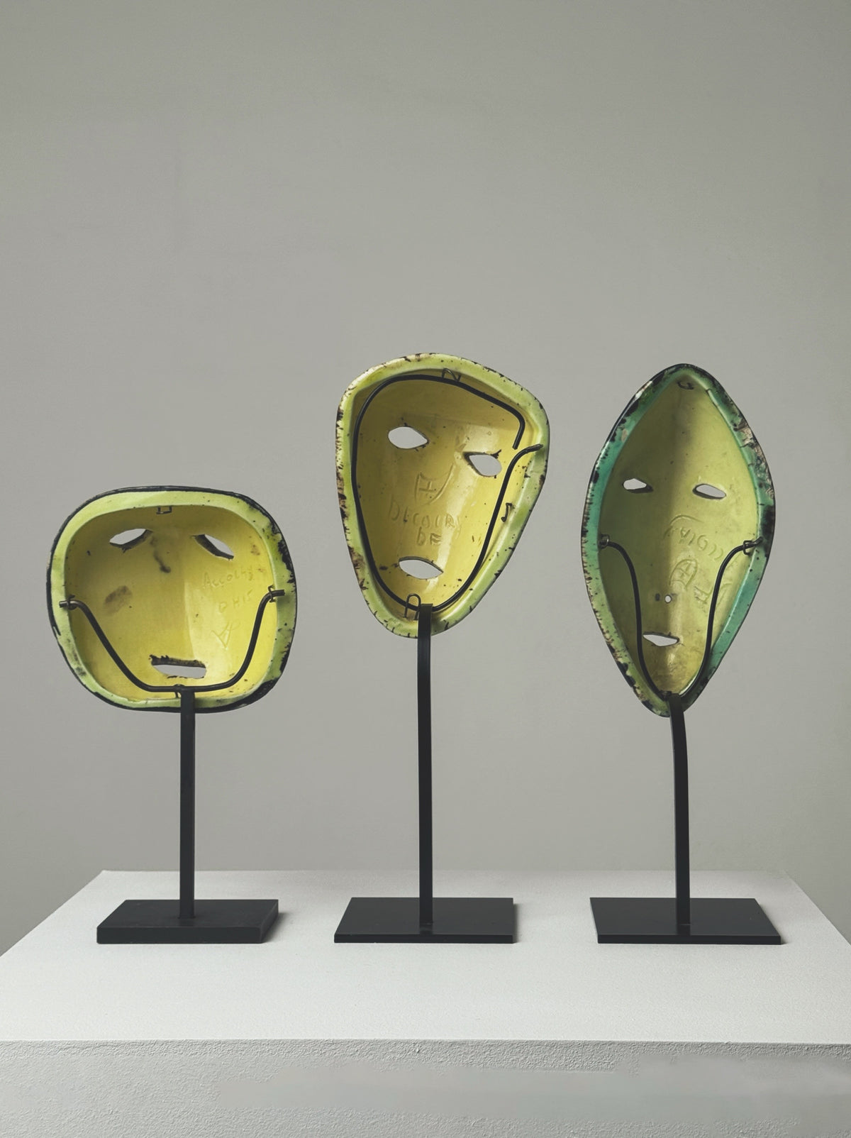 Three modernist ceramic masks by Accolay Potters on stands