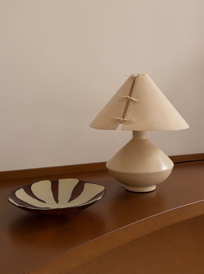 Bone ceramic table lamp with linen shade styled on wooden console