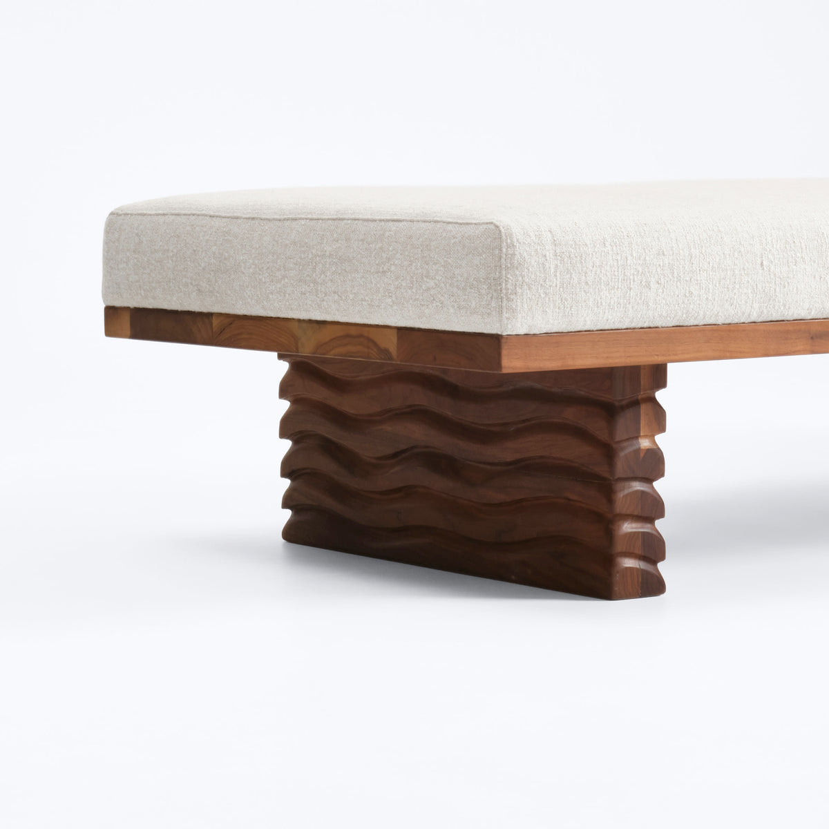 Nazaré Daybed — angled view showing textured wood base and fabric cushion