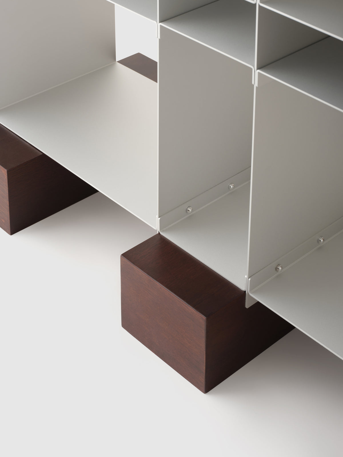 White modular shelf with walnut wood base detail view