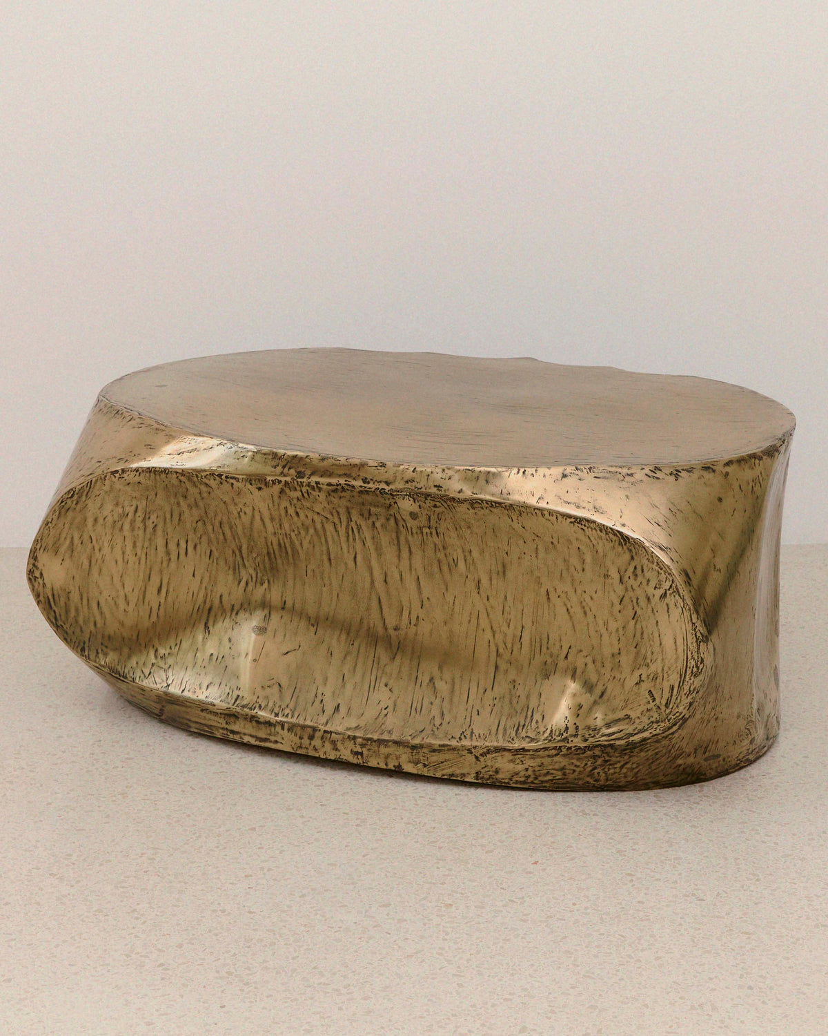ROCHER brass resin coffee table showing organic curved form
