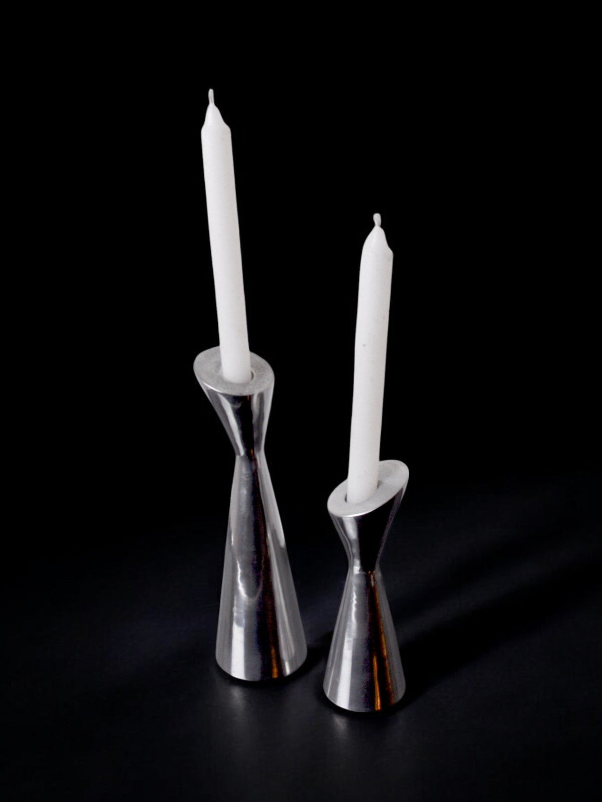 Pair of Swan candlesticks by Matthew Hilton, England, 1980 — side angle