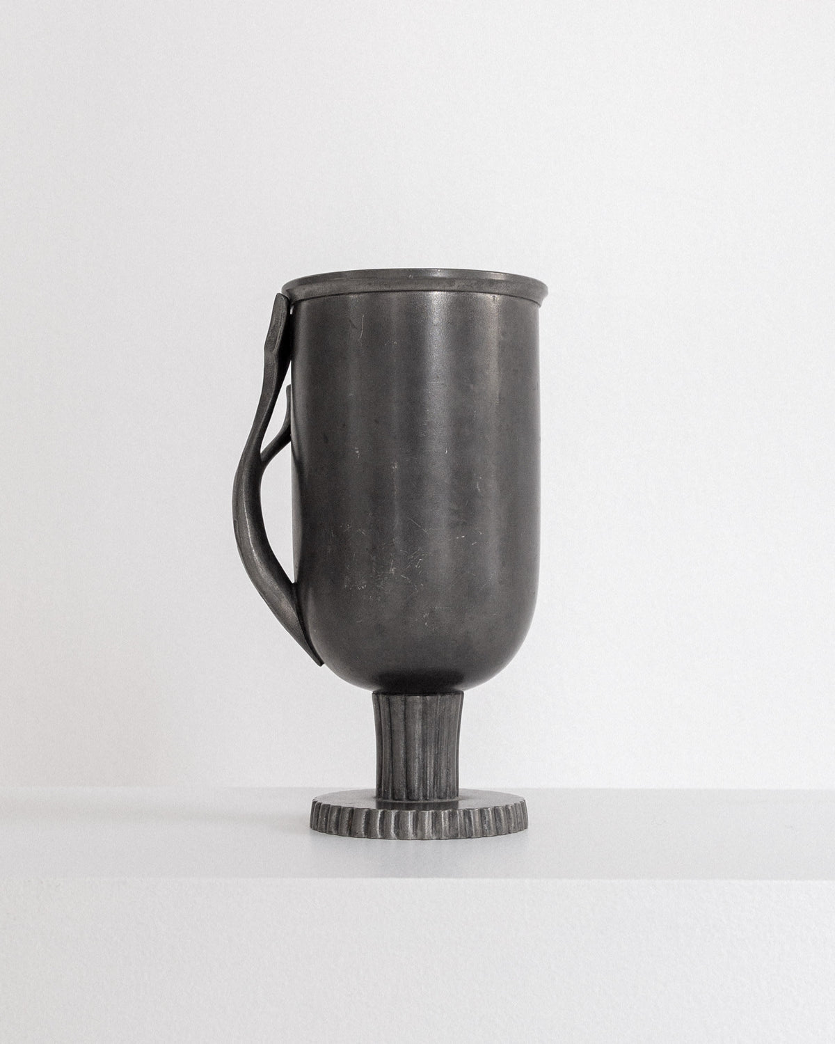 Elegant Swedish pewter vase profile view showing classical handle