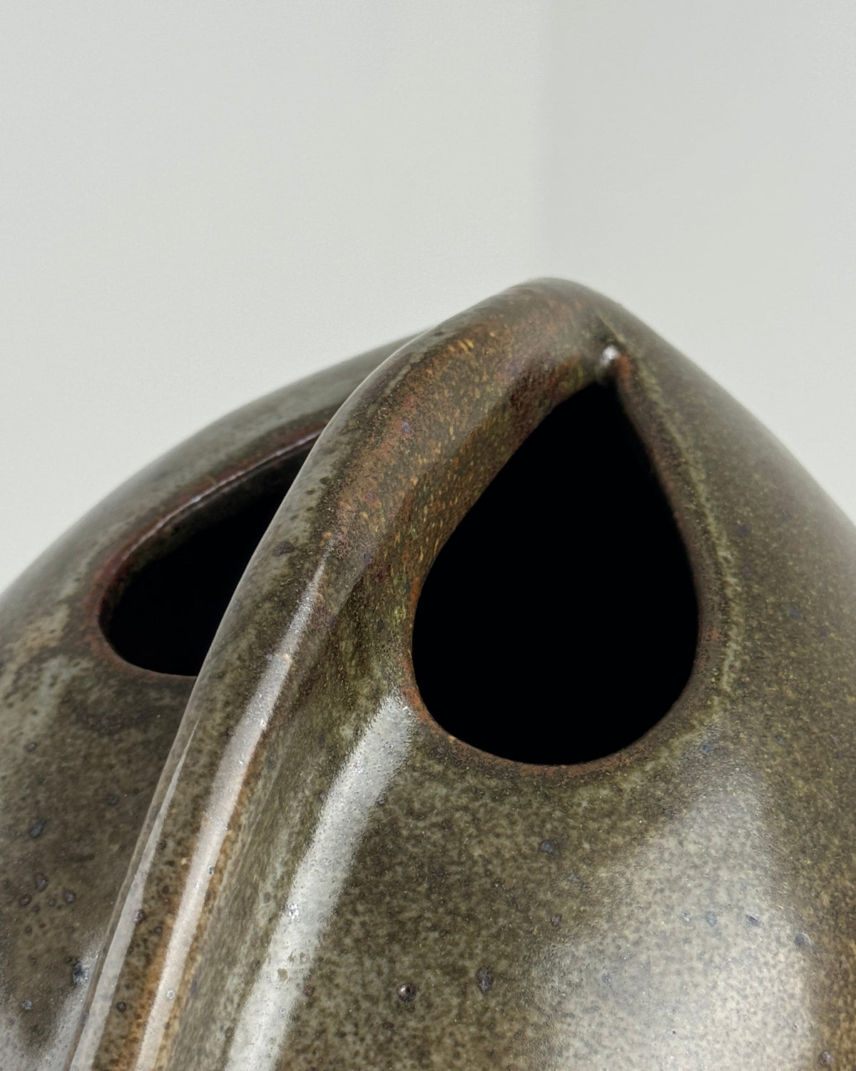 Close-up of stoneware vase opening showing glazed rim detail