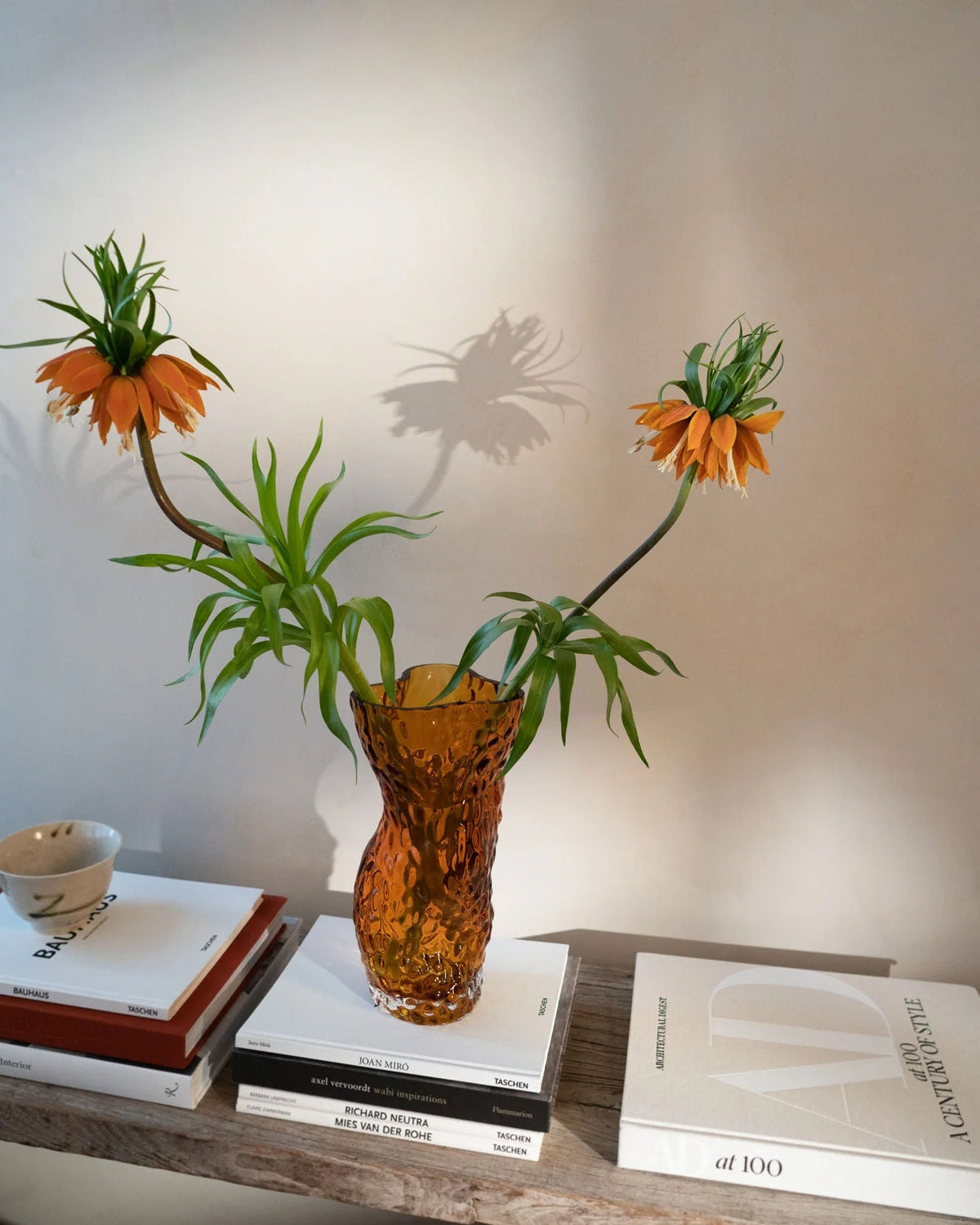 Ostrea Rock Glass Vase - Amber — back view with flowers on wooden shelf