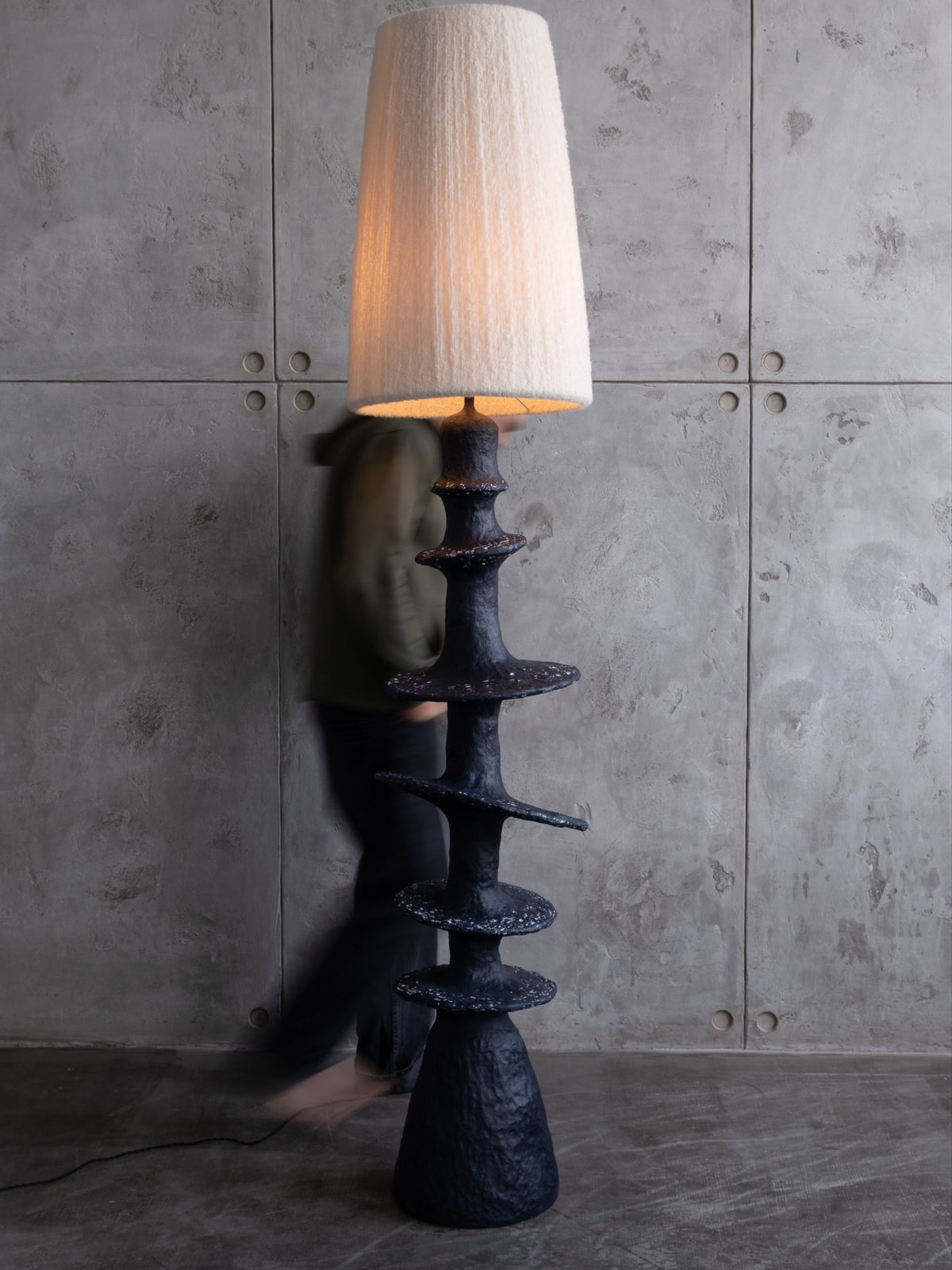 Orbita Floor Lamp — side angle with textured black base and fabric shade