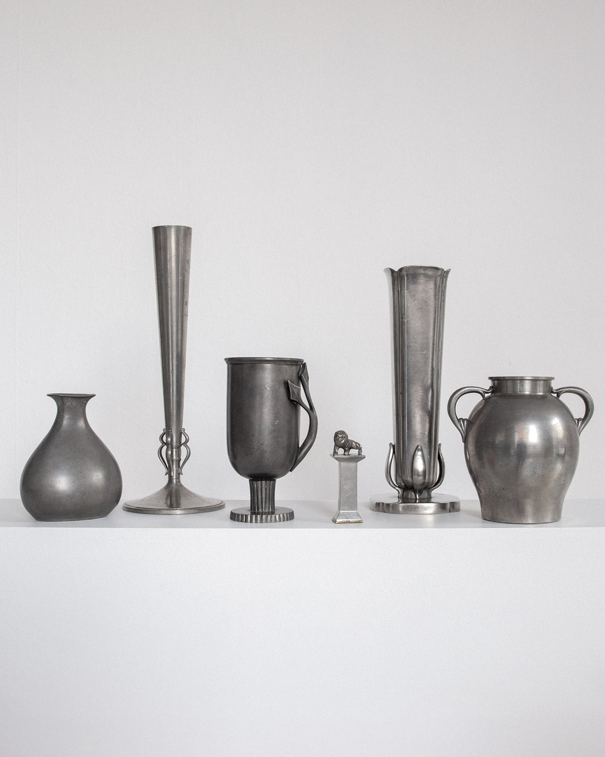 Collection of six modernist pewter vessels including featured GAB vase from 1937