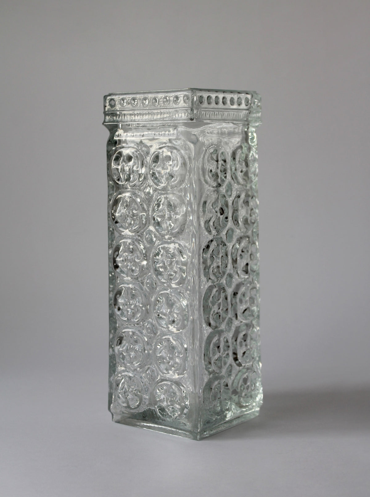 Clear glass rectangular vase with embossed circular pattern by A. Matura