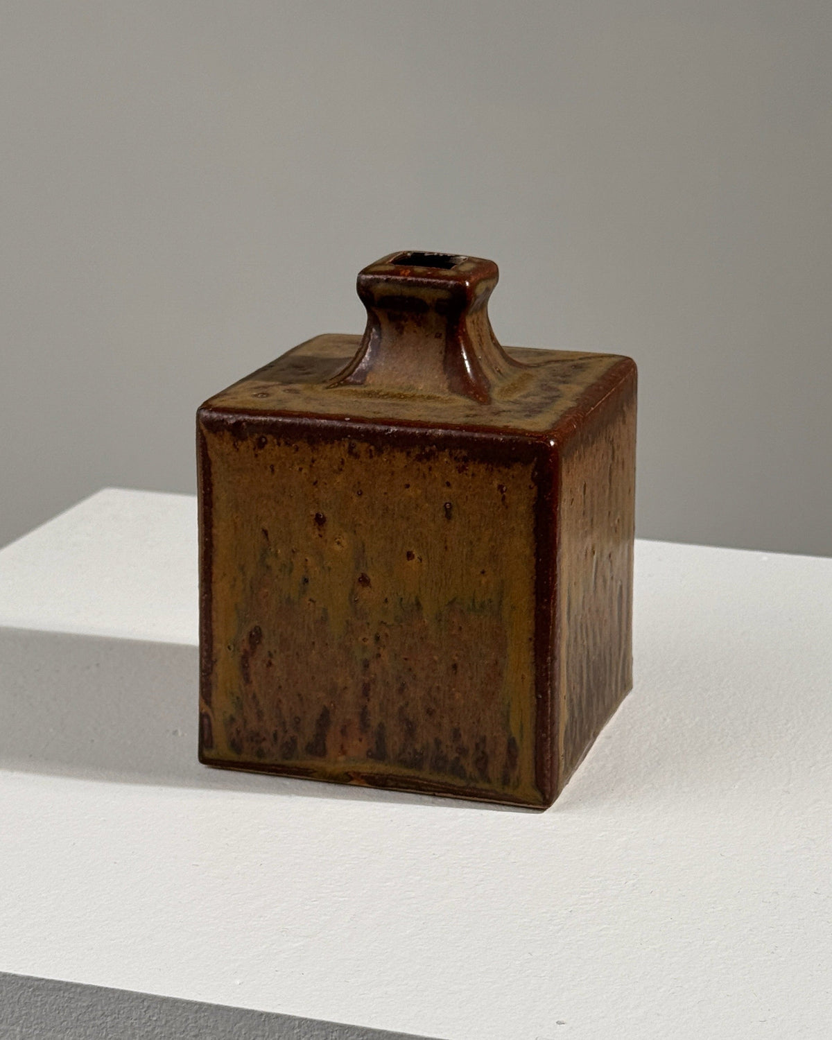 Brown glazed ceramic square vase with textured finish and neck spout