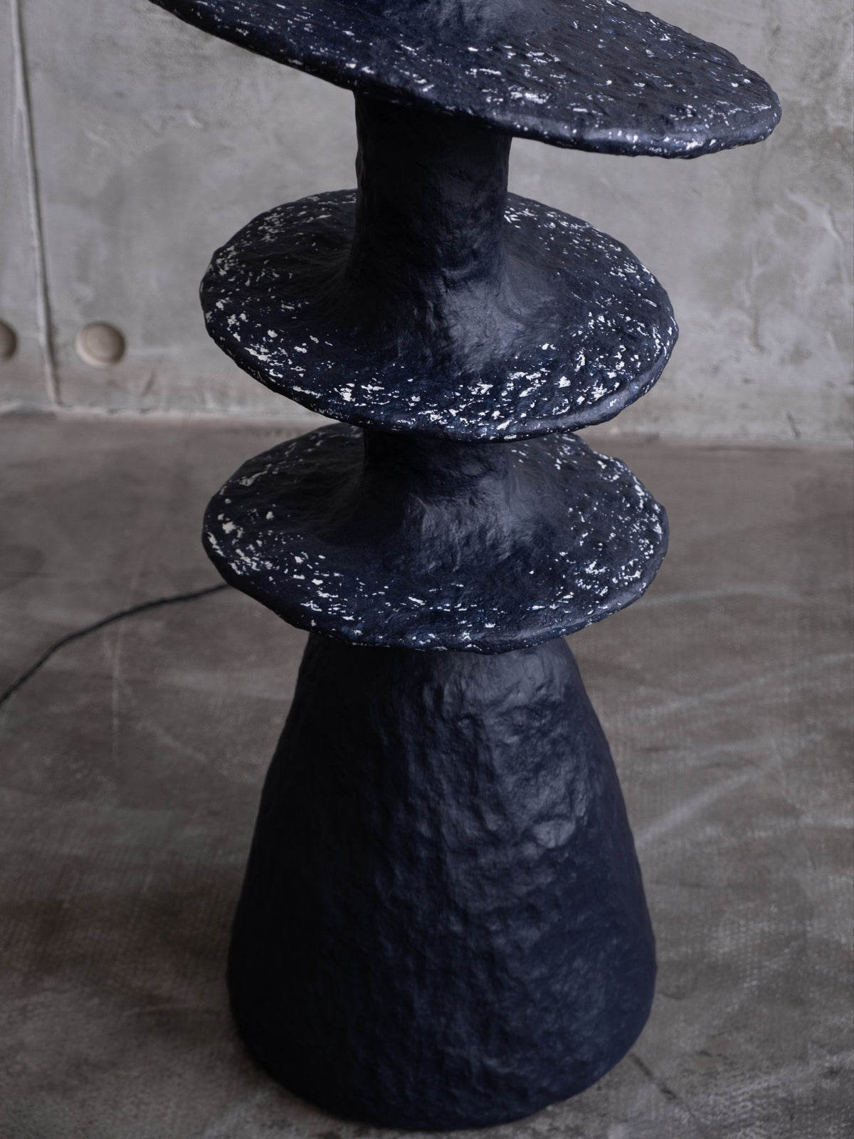 Orbita Floor Lamp — top view of textured black surface