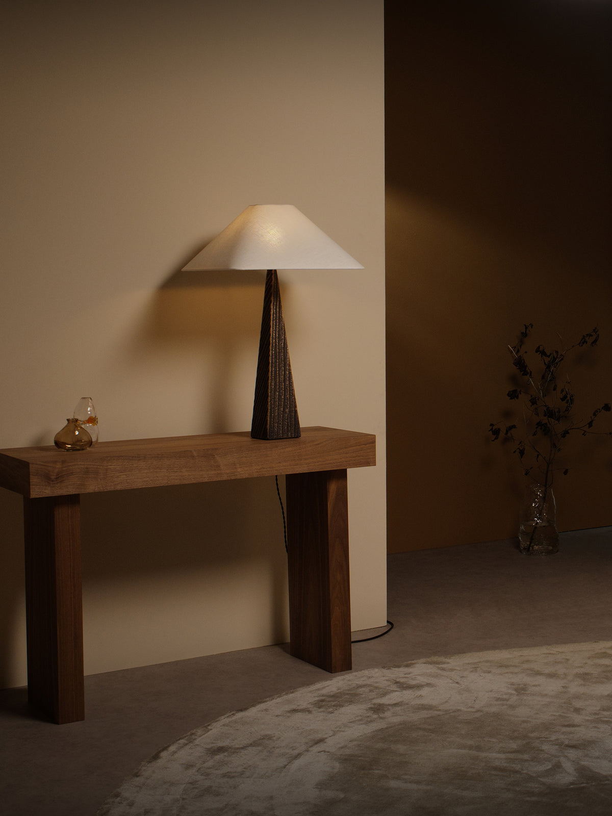 CUBIST Table — side angle on wooden console in warm setting