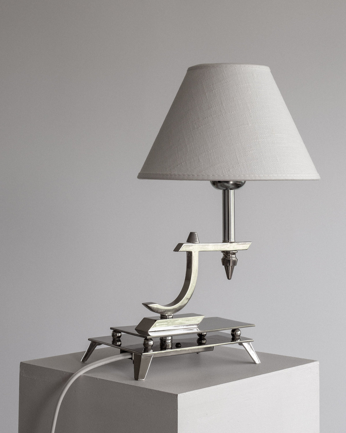 Sculptural Chrome Art Deco Table Lamp, 1930s — side angle on white pedestal