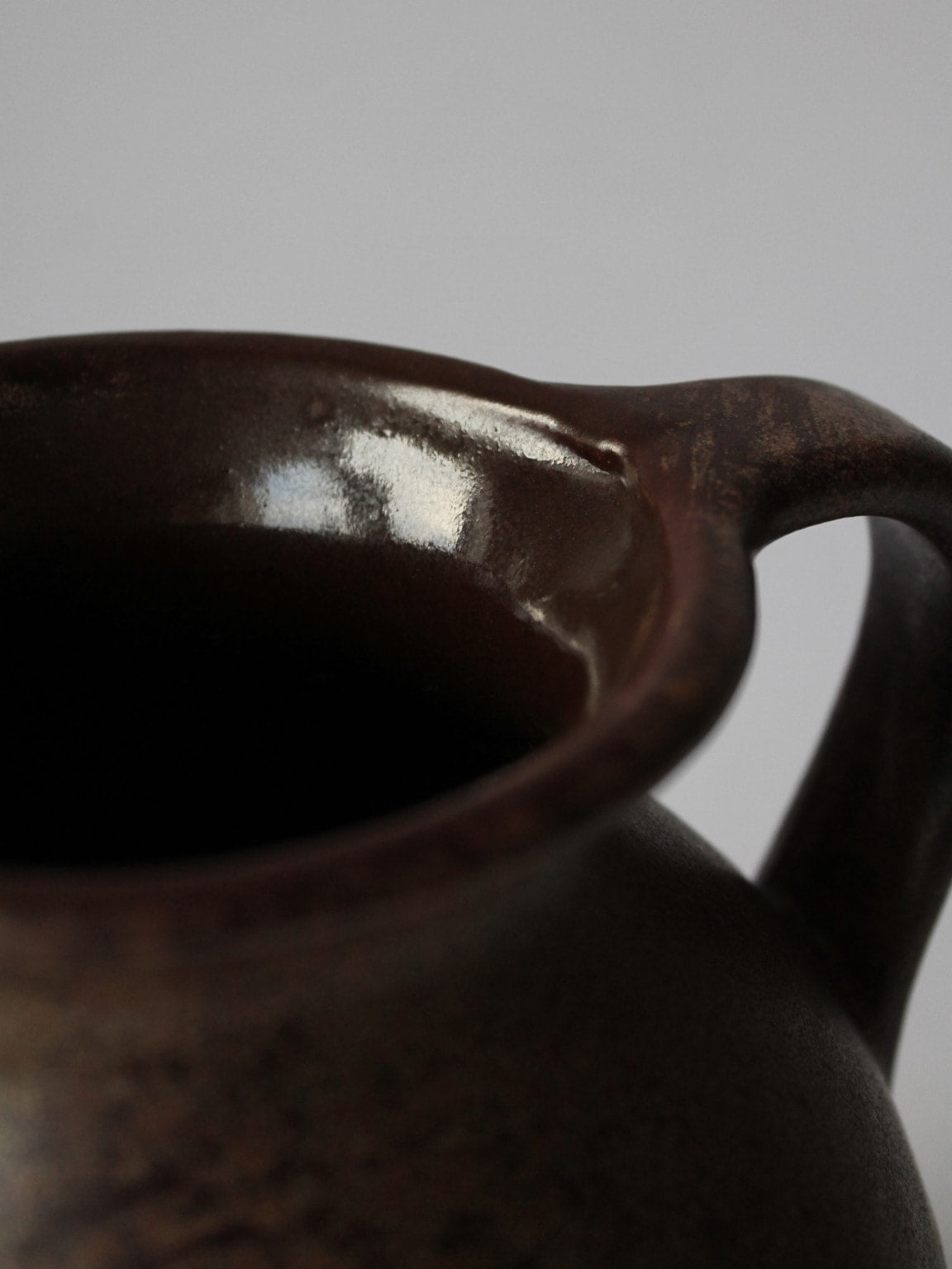 Close-up detail of German Fat Lava ceramic jug brown glaze