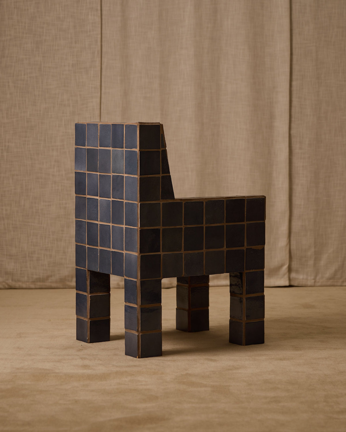 Jura tiled accent chair with pixelated dark blue ceramic squares
