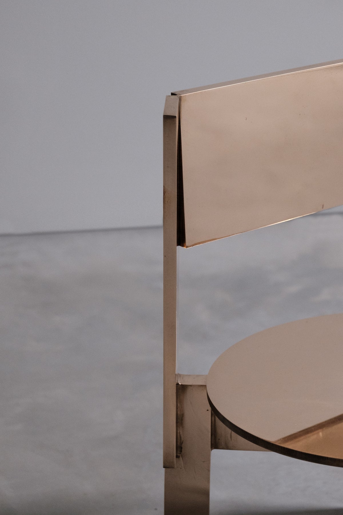 Ch 19.1 [b] - Low Chair — side angle showing polished brass finish