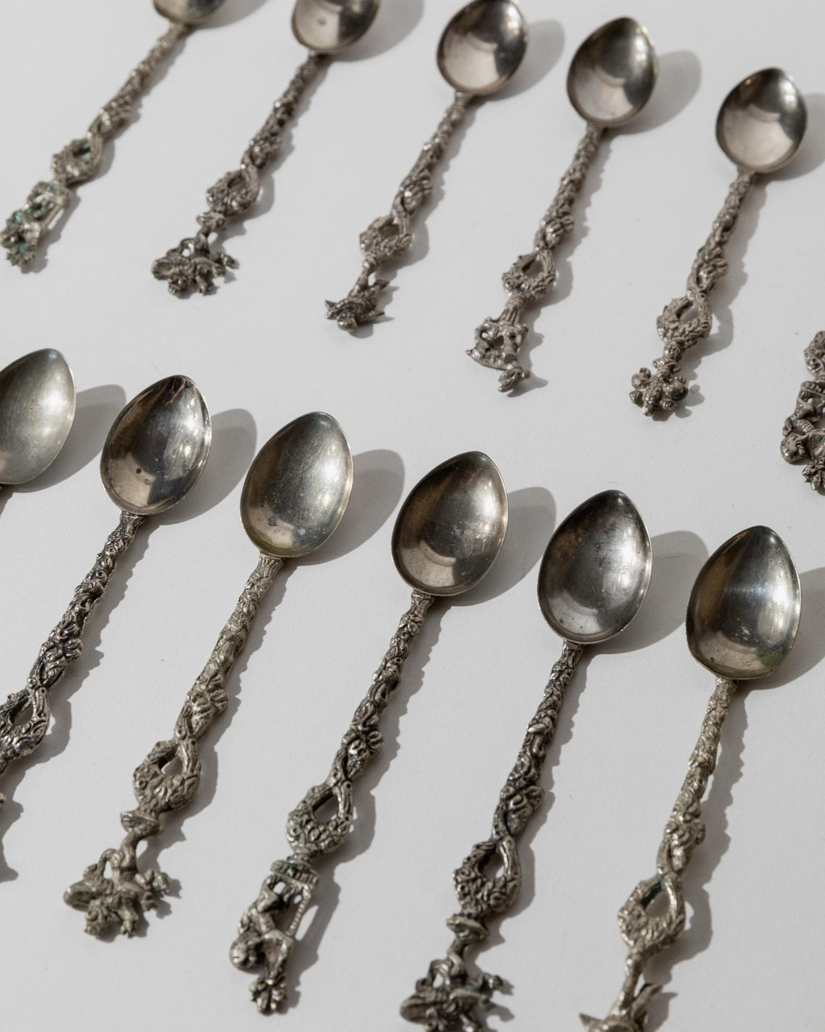 Vintage 1930s Silver Plated Tea and Cake Serving Set, 13 Ornate Spoons with Heraldic Figures and 1 Cake Server, Italian Tableware, Gift Idea — side angle