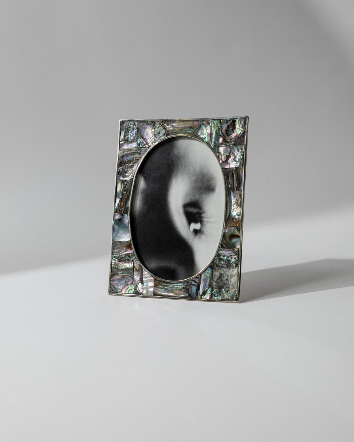 Vintage 1950s Alpaca Silver Picture Frame, Mother of Pearl Details with Oval Photo Opening, Elegant Table Accent, Timeless Gift Idea — in context
