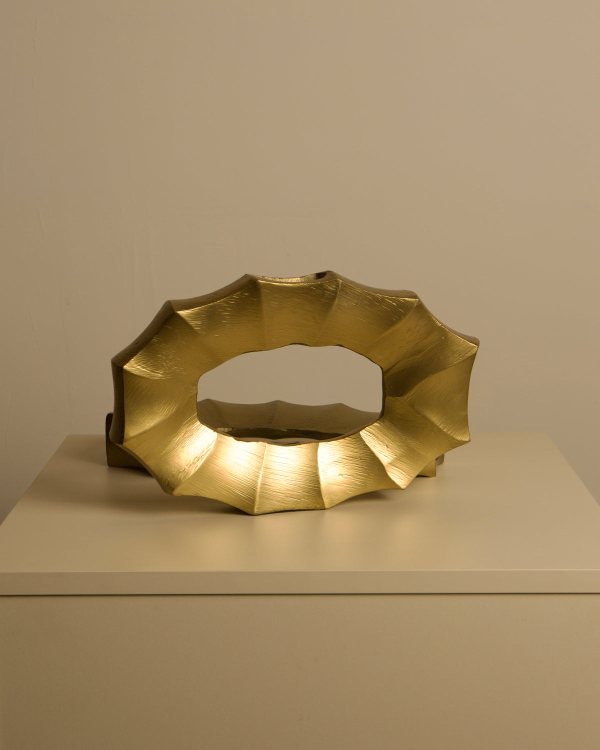 Pair of Italian 80s Gilt Aluminum Vases — angled view on neutral surface