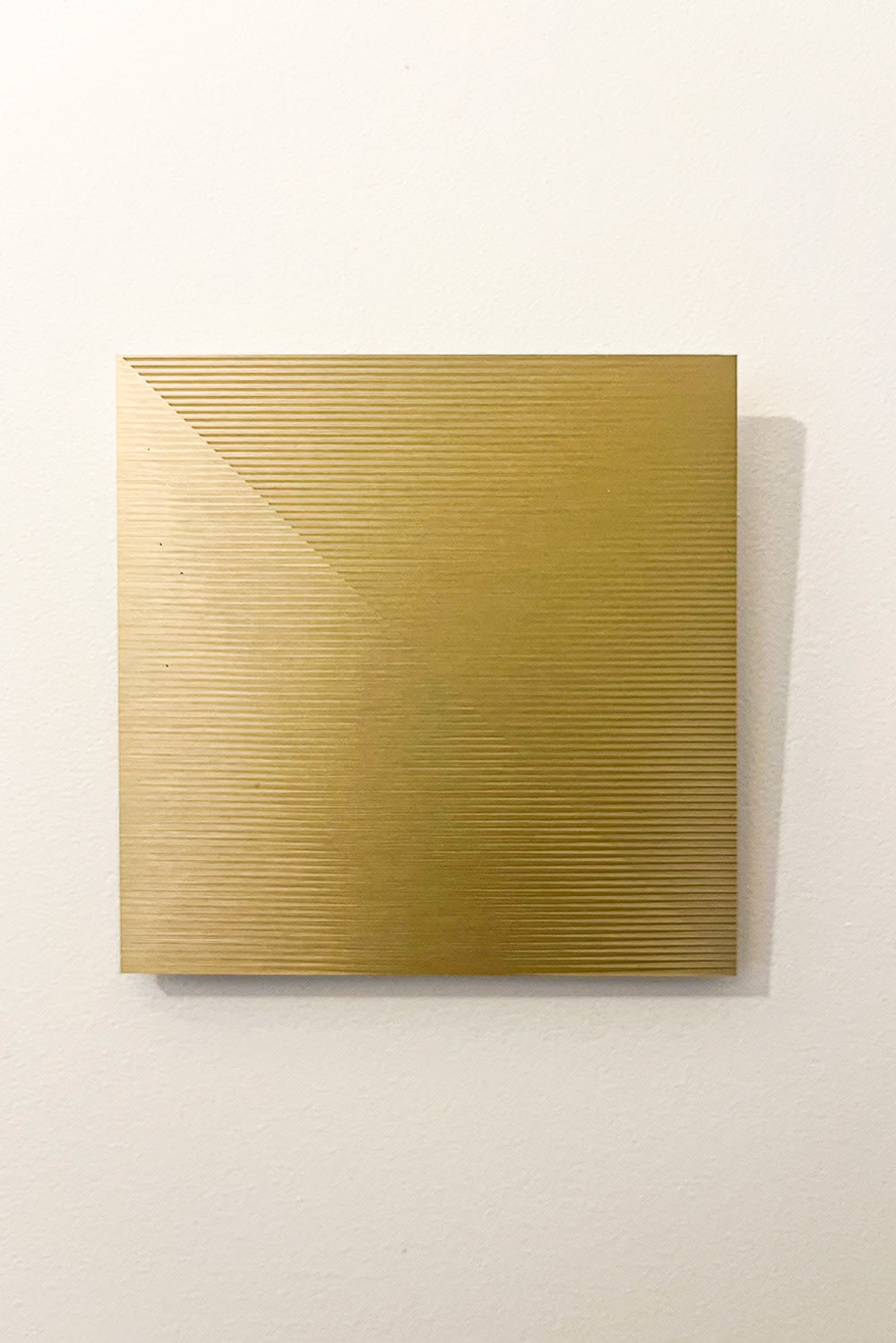Gold brushed aluminium minimalist wall sculpture OSMOSE by Paul Gallaud