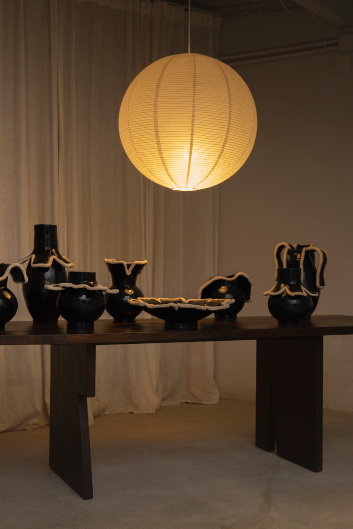 Navy blue ceramic collection styled display with globe pendant light