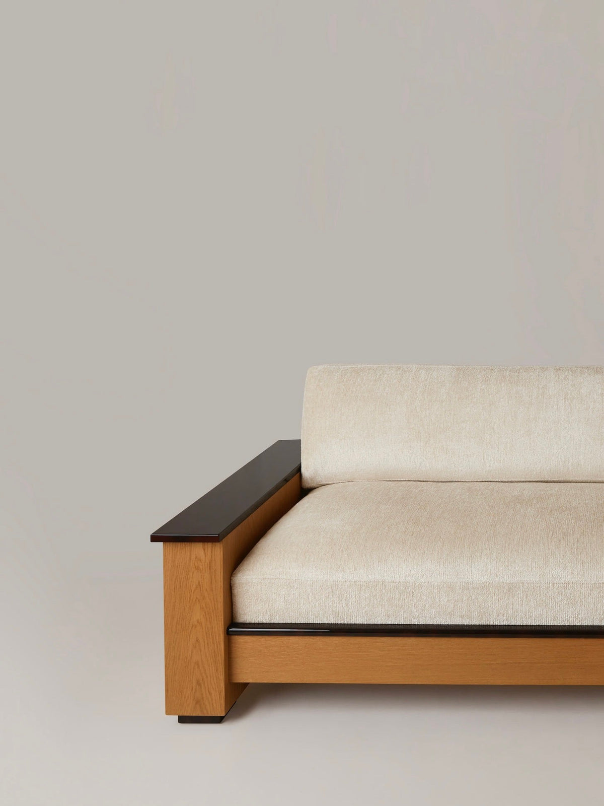 Le Colonel" Sofa (3-4 seater) — angled view highlighting beige upholstery and wooden frame
