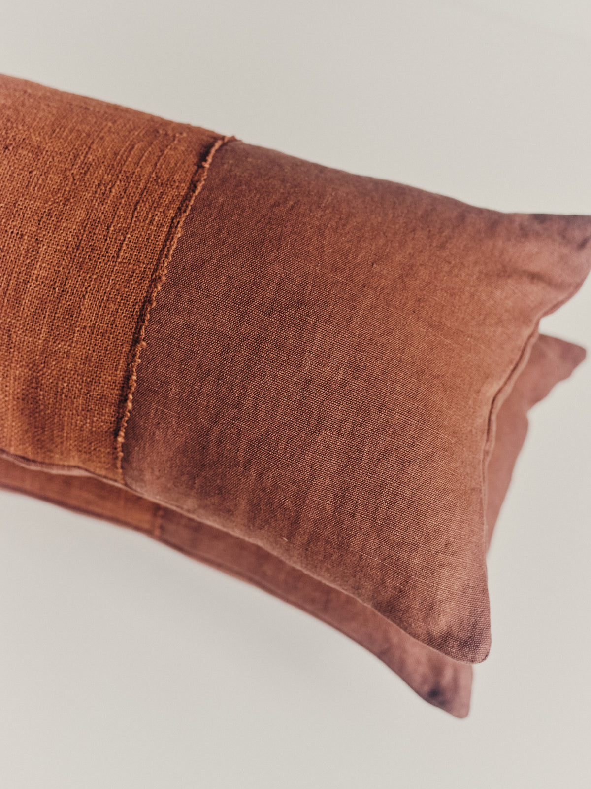 Handwoven brown cushion in hemp and cotton  — side angle