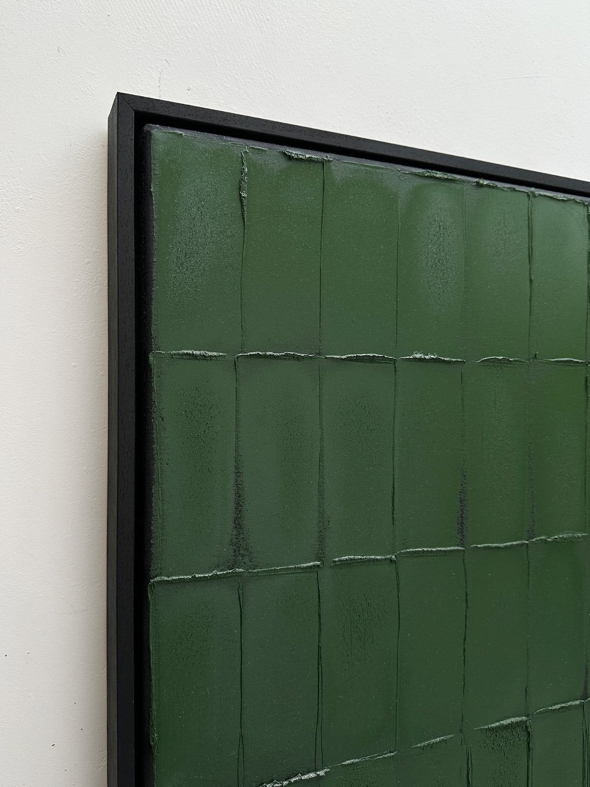 Close-up detail of green textured brushstrokes on Terre Verte painting