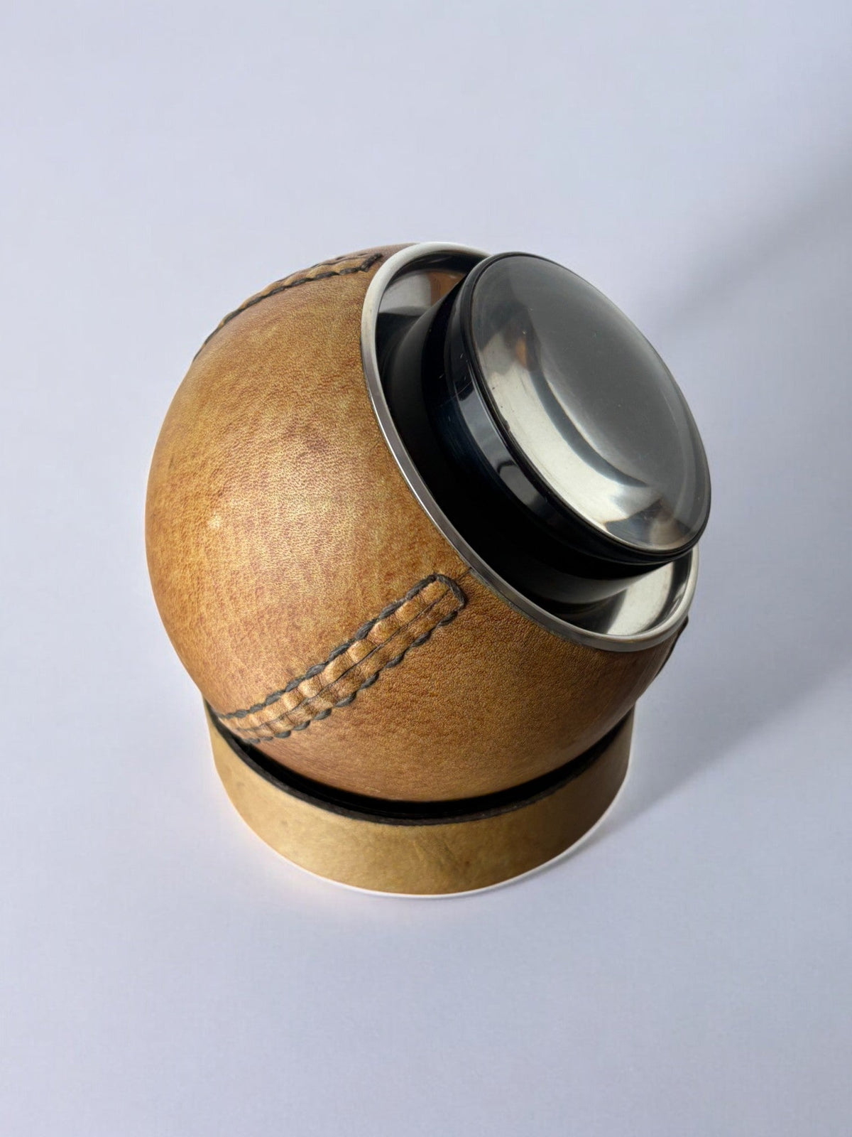 Circular cigarette box with support in leather, Spain, 1980's — side angle
