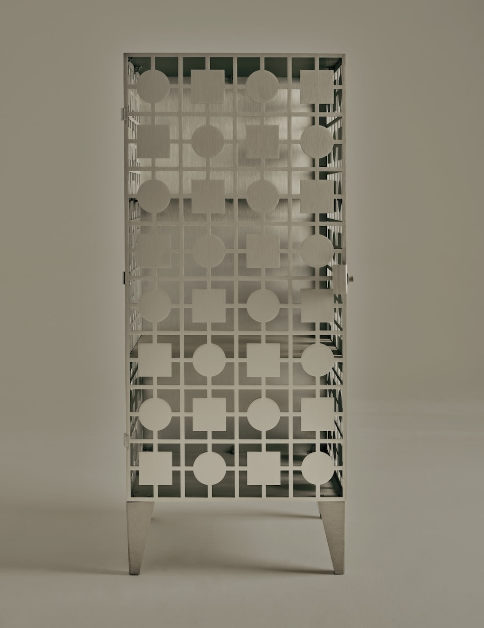 White geometric patterned cabinet with circles and squares design