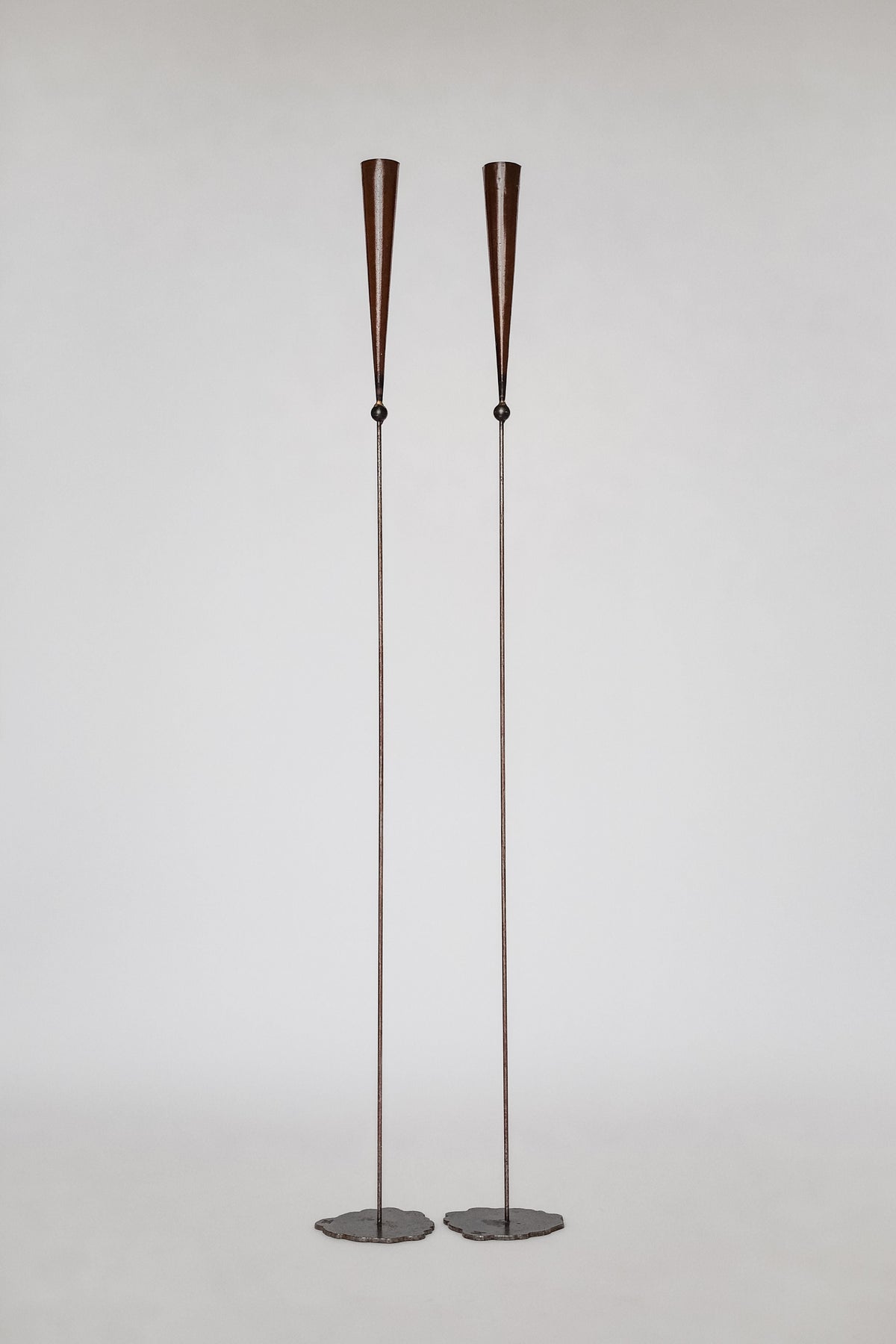 Pair of tall copper candle sconces with conical shades by Pieter Spruyt