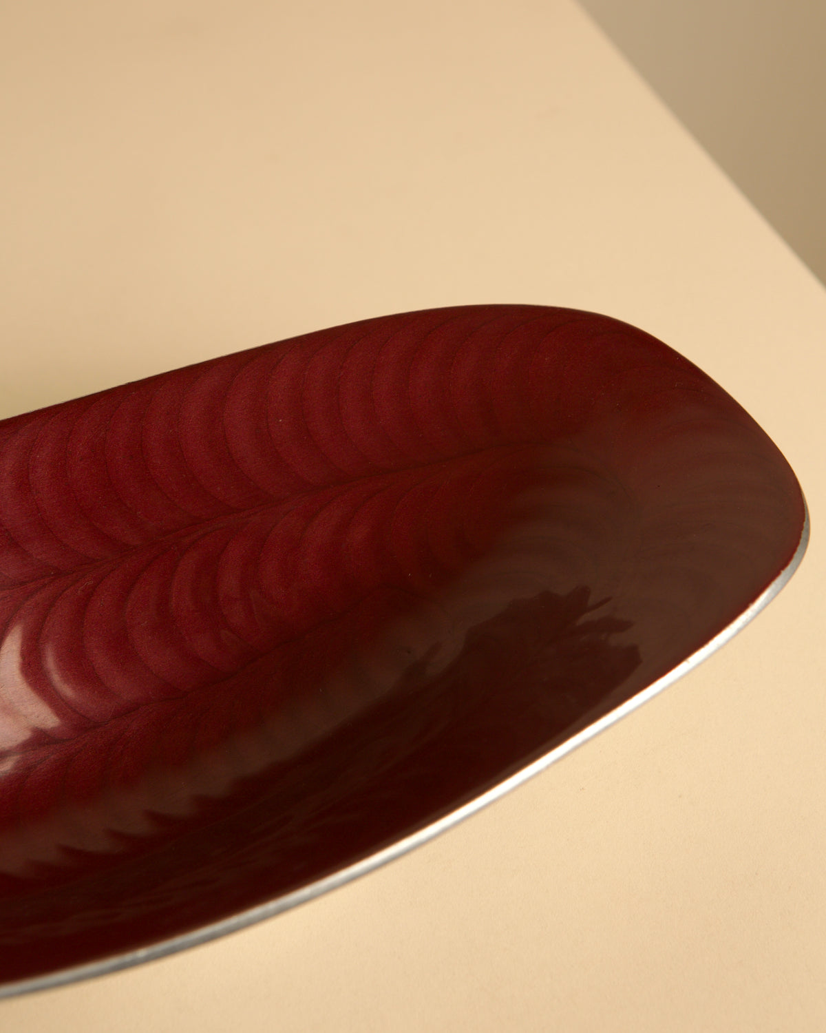 Italian burgundy aluminium "Galassia" catch-all by Brandani, 1980s — lifestyle setting