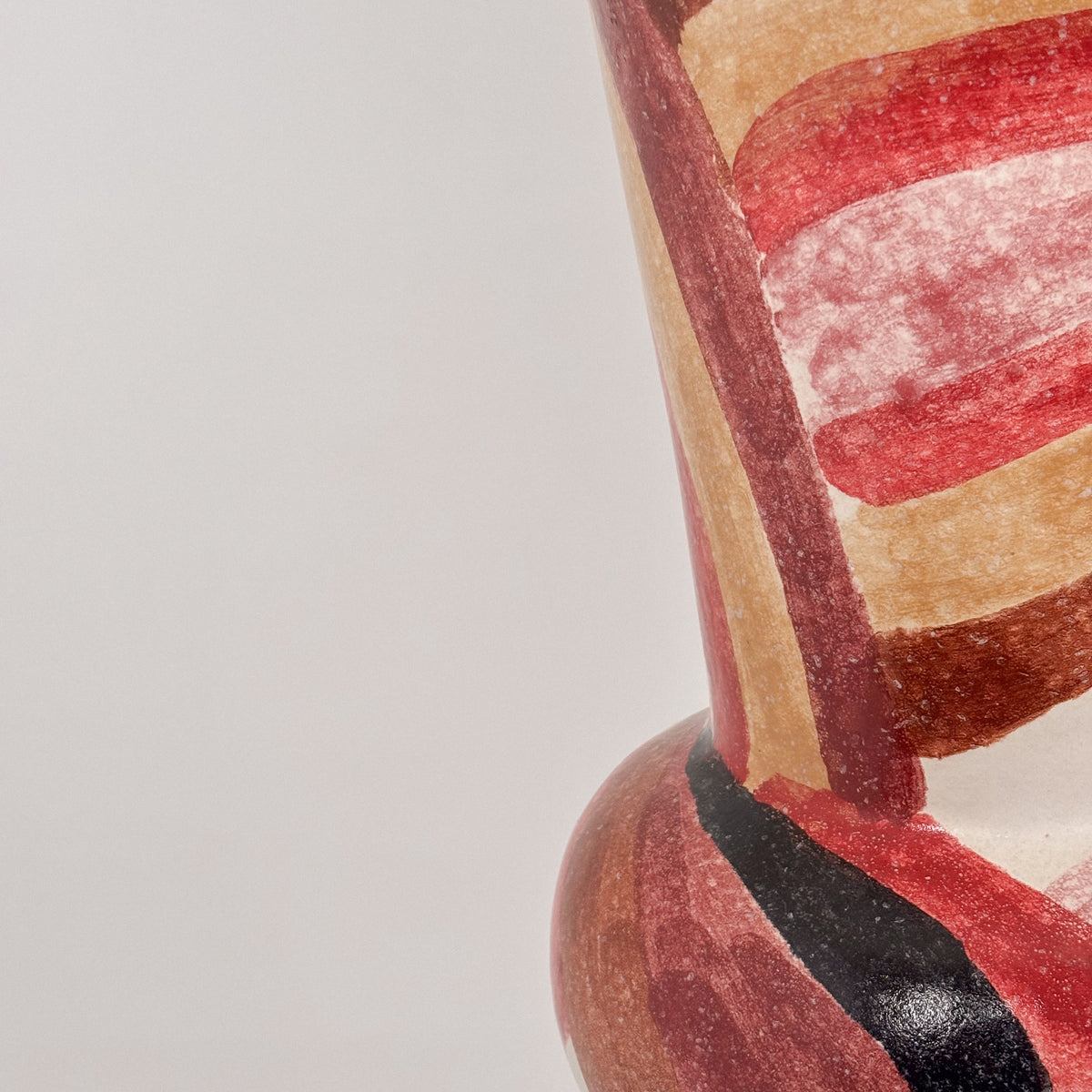 Bottom detail view of large ceramic table lamp with red glaze patterns